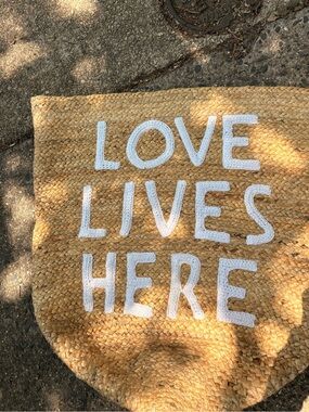 LOVE LIVES HERE Woven Jute Tote - Natural with White Letters